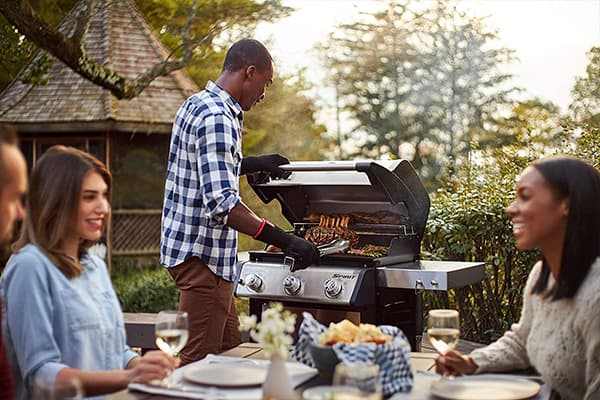 Man preparing a barbecue on the Weber Spirit S-315